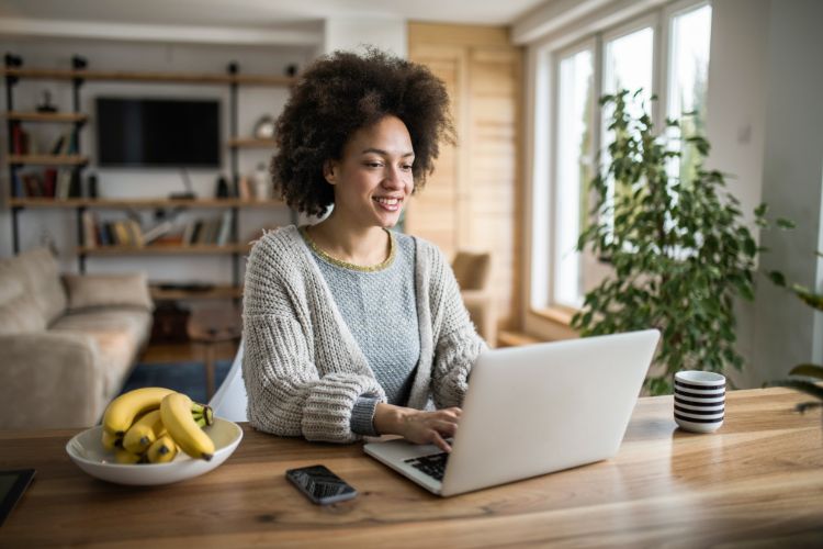 A beginner learning HTML on her laptop computer.